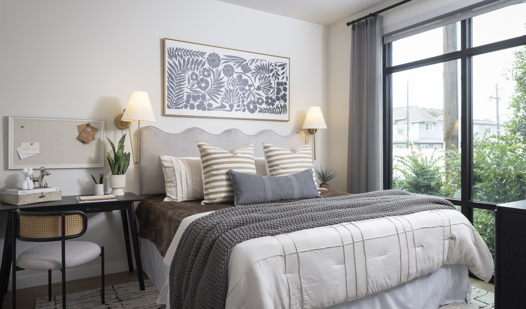 bed with pillows and desk beside it at Broadstone Amarra Apts