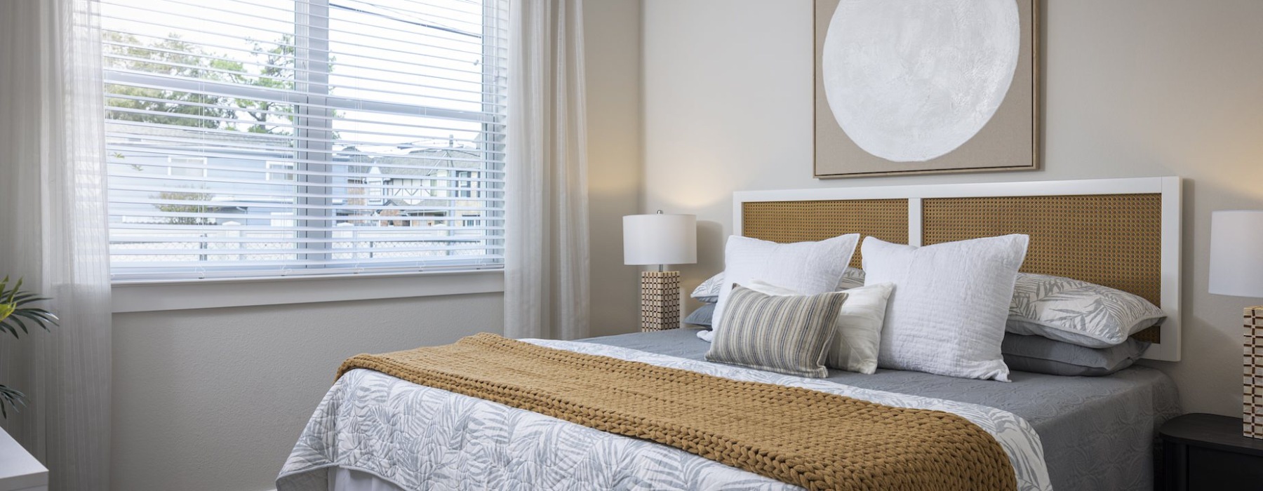 Bedroom with pillows and large window in the back