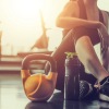 a person in a gym sitting down next to exercise equipment