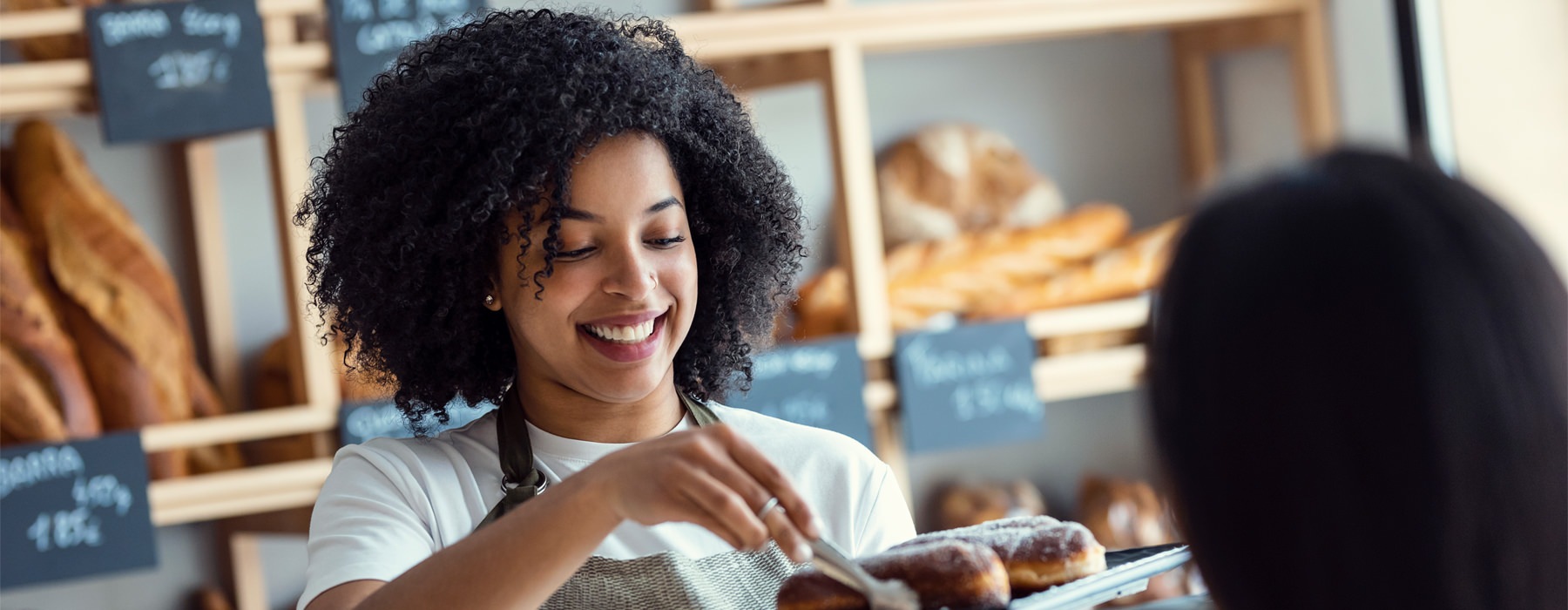 a woman serving a customer in a store